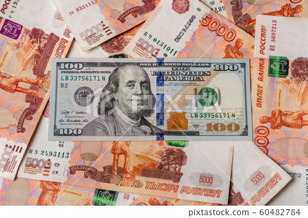 American hundred dollars on the background of Russian 5000 rubles. American hundred dollars on the background of Russian 5000 rubles. 60482784