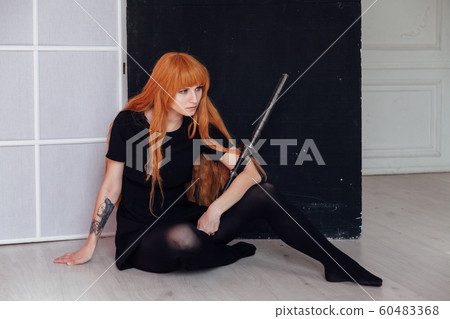 woman anime with red hair with Japanese samurai sword in dress woman anime with red hair with Japanese samurai sword in dress 60483368