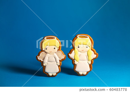 gingerbread cookie of cute little angels on blue 60483778