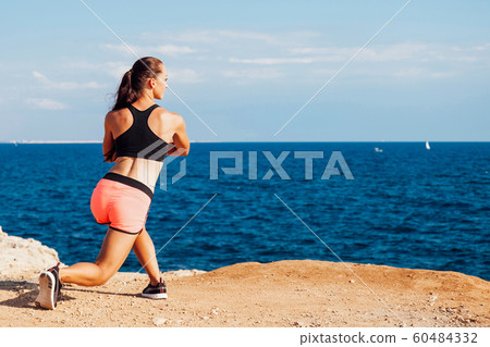 woman goes in for Sports Fitness on the beach 60484332
