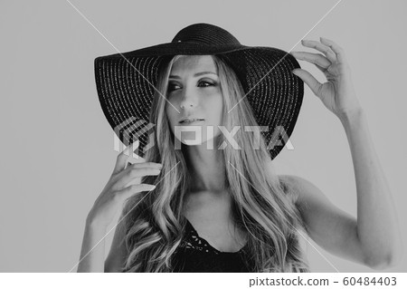 blonde girl with blue eyes a hat with a brim on a white background 60484403