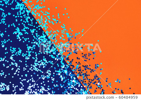 Flat lay with shiny sequins on blue and orange background. 60484959