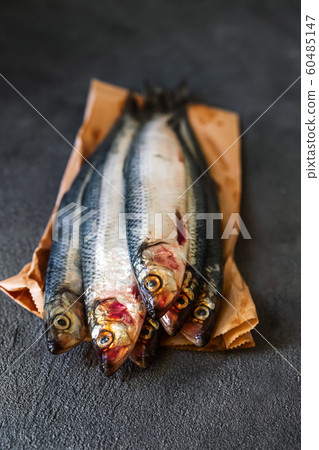 Raw herring fish on a dark background 60485147