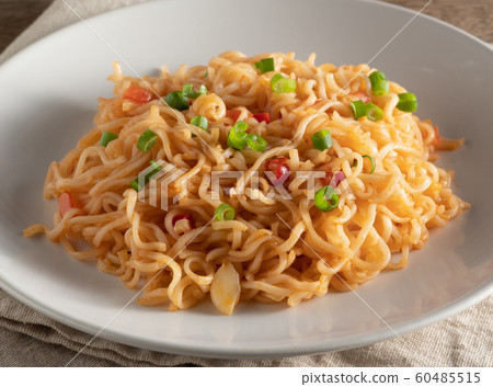 The noodles are in a round white plate 60485515
