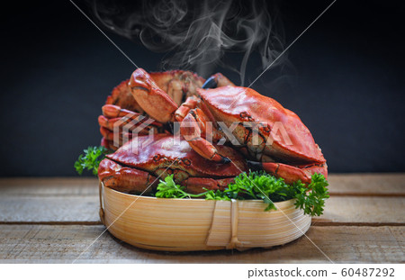 Cooked crab on steamer and dark background - 60487292