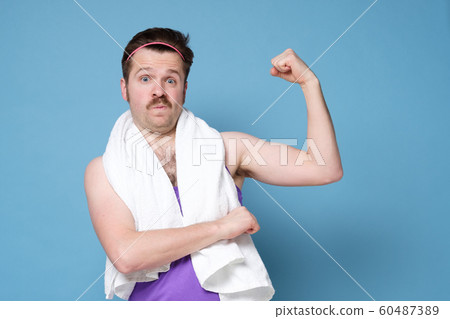 Funny manwith mustache and white towel showing his muscles 60487389