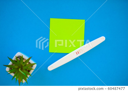 The result is positive. Close up of pregnancy test and contraceptive pills birth control concept on blue background The result is positive. Close up of pregnancy test and contraceptive pills birth control concept on blue background 60487477