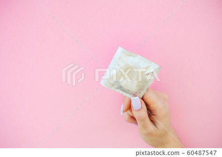 Contraception. Birth Control Pills and an unwrapped Condom. Colored Pills And Capsule On Pink Background. Pharmacy Theme, Capsule Pills With Medicine Antibiotic in Packages Contraception. Birth Control Pills and an unwrapped Condom. Colored Pills And Capsule On Pink Background. Pharmacy Theme, Capsule Pills With Medicine Antibiotic in Packages 60487547