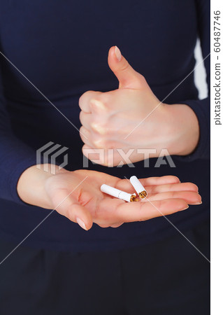 Stop Smoking. Beautiful Woman Breaking Cigarette In Half Stop Smoking. Beautiful Woman Breaking Cigarette In Half 60487746