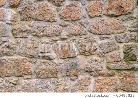 Ancient red stone wall flat background closeup 60495028