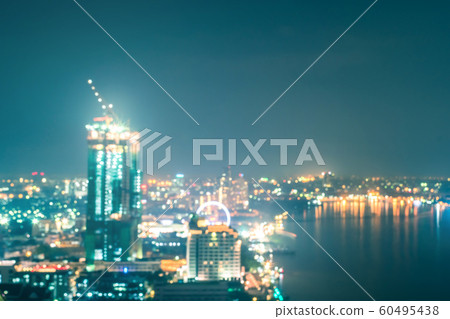 Blur city background rooftop view of cityscape business building landscape night lights bokeh in cool vintage blue tone 60495438