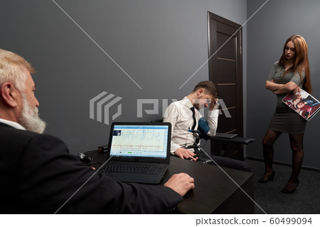 Sad man answering questions during lie detector test 60499094