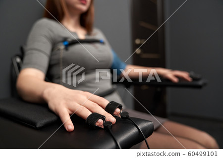 Hand with indicator measuring pulse during lie detector test Hand with indicator measuring pulse during lie detector test 60499101