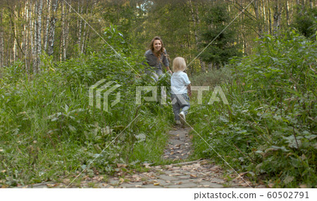 Young attractive woman playing with small boy 60502791