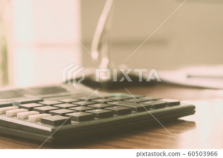 Close up of a calculator placed on office desk. Close up of a calculator placed on office desk. 60503966