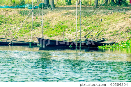 Bird watching rowing boats on the shore of wetland of Chupir Chor oxbow lake Bird watching rowing boats on the shore of wetland of Chupir Chor oxbow lake 60504204