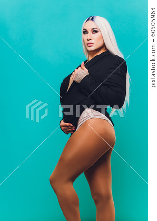 Portrait of young transgender woman on color background. Portrait of young transgender woman on color background. 60505963