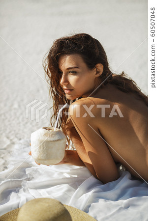 Woman with Coconut Drink on the Beach Woman with Coconut Drink on the Beach 60507048