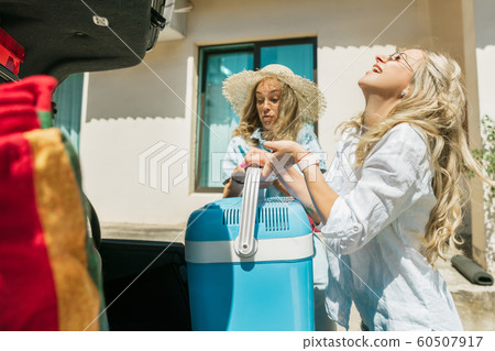 Young lesbian's couple preparing for vacation trip on the car in sunny day 60507917