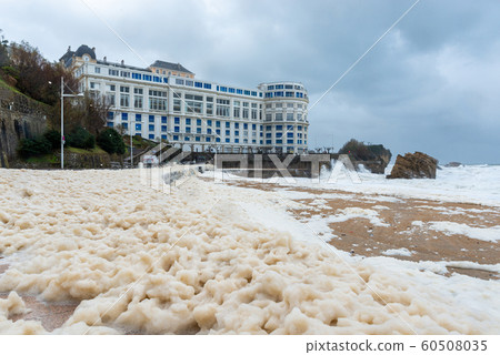 Foam on the Grande Plage beach and its quay, France 60508035