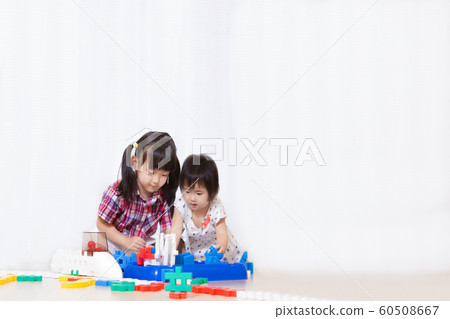 Two little girls playing with blocks. Play, sister, friendship, educational image 60508667