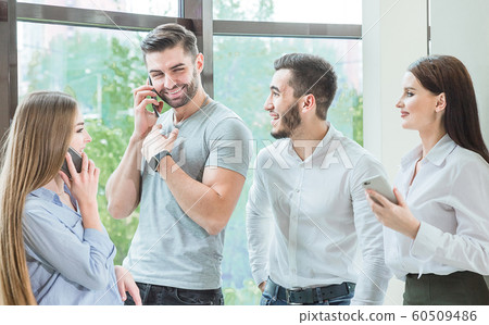a company of friends, employees make a telephone prank 60509486