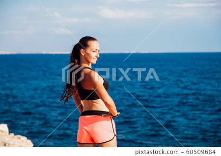 woman goes in for Sports Fitness on the beach 60509684