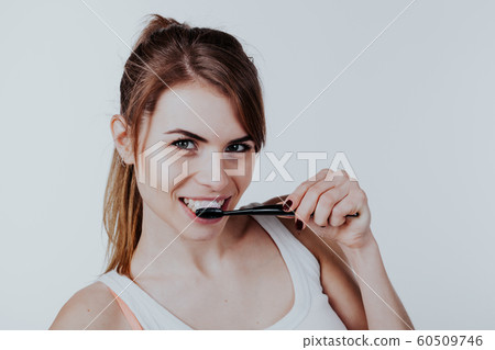 pretty girl in the bathroom brushing his teeth smile 60509746