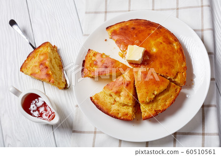 sliced hot Cornbread topped with melted butter 60510561