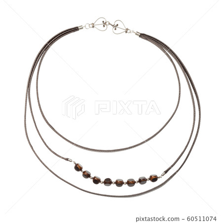 leather strip and bone beads necklace isolated leather strip and bone beads necklace isolated 60511074