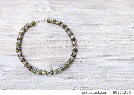 top view of arabic jadeite necklace on gray 60511230