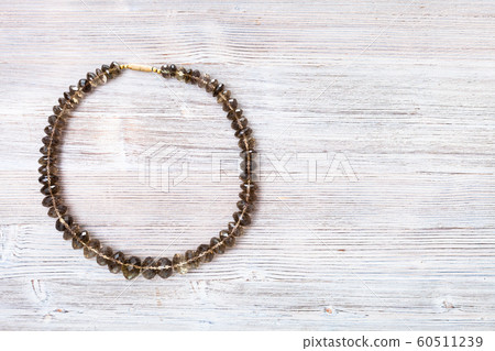 top view of faceted smoky quartz necklace on gray 60511239