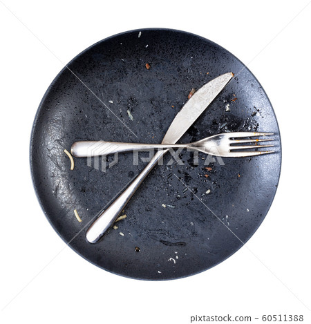 crossed knife and fork on dirty plate after lunch 60511388