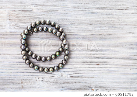 top view of coiled natural black pearls beads 60511792