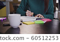 Phone on desk. Young brunette businesswoman work in office table. 60512253