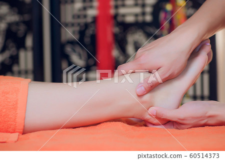 reflexology foot massage, spa foot treatment close-up. 60514373