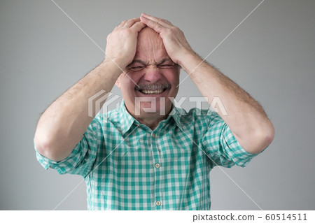 Thinking caucasian senior man holding hands on head. 60514511