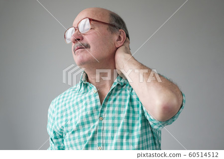 Caucasian mature man suffering from neck pain. 60514512