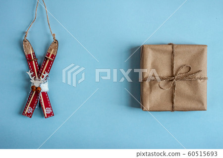 wooden toy ski and wrapped gift blue background wooden toy ski and wrapped gift blue background 60515693