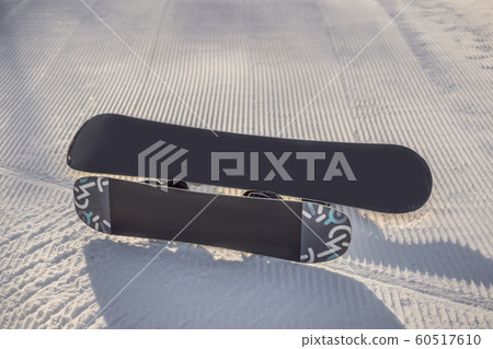 groomed empty ski piste background with snowboards 60517610