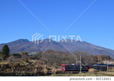 Shinano Railway 115 series running against the winter sunny Asama mountain Shinano Railway 115 series running against the winter sunny Asama mountain 60518801