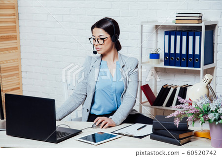 business girl Secretary sits in a white Office call center business girl Secretary sits in a white Office call center 60520742