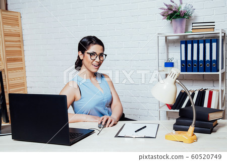 business girl sits in a white Office works at the computer business girl sits in a white Office works at the computer 60520749