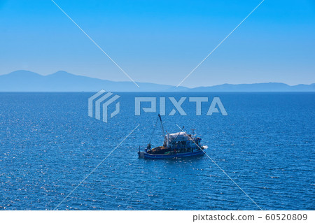 Fishing boat on the water catching fish 60520809