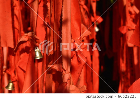 red cloth tight with bell and write name hanging for wealth and luck in Thailand Buddhist temple red cloth tight with bell and write name hanging for wealth and luck in Thailand Buddhist temple 60522223