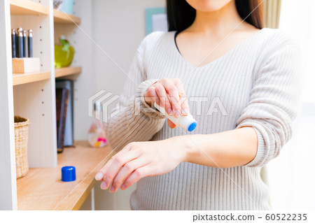 Woman applying insect bite medicine Woman applying insect bite medicine 60522235