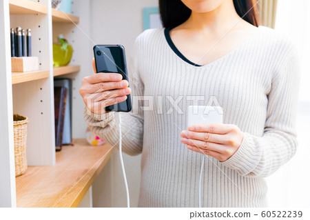 Smartphone charging woman mobile battery pocket charger 60522239