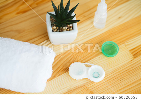 Vision And Medicine Concept. Accessories for contact lenses: contact lens case, tweezers, solution 60526555