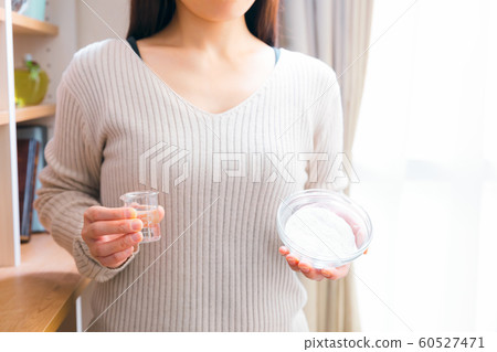 Woman making baking soda paste 60527471