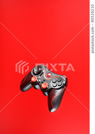 Game controller in flight on red background. Game controller in flight on red background. 60529210